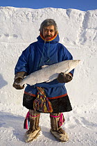 Man with a large Nelma (white Salmon) caught at Syuneysale. Yamal, Northwest Siberia, Russia, February 2007. Editorial use only.