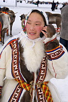 Nenets woman using a mobile phone. Yamal, Northwest Siberia, Russia, February 2007. Editorial use only.
