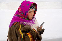 Khanty woman using a mobile phone in Nadym. Yamal, Northwest Siberia, Russia, February 2007. Editorial use only.