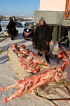 Nenets herder selling Reindeer (Rangifer tarandus) meat at a market in Salekhard. Yamal, Western Siberia, Russia, August 2008. Editorial use only.