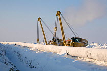 Gas pipeline being constructed in winter near the Yurharovo gas field. Noviy Urengoi, Yamal, Western Siberia, Russia.