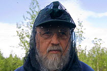 Man using head net as essential protection from mosquitoes and black flies during the summer in Siberia, August 2008. Model released