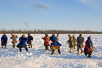 Nenets men competing in a lassoing competition at a reindeer herders festival in the Yamal. Western Siberia, Russia, February 2009.