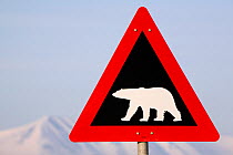 Road sign warning of Polar bears, with the mountains of Adventdalen in the distance. Spitsbergen, Svalbard, Norway, June 2008.