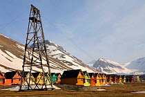 Houses and industrial archaeology in valley between the mountains. Longyearbyen, Svalbard, Norway, June 2008.