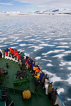 Passengers on Icebreaker "Professor Mulchanov" looking for wildlife in Brepollen. Hornsund, Svalbard, Norway, June 2008.