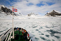 Tourists on the bow of the "Professor Mulchanov" looking for wildlife. Hymebreen, Hornsund Fjord, Spitsbergen, Svalbard, Norway, June 2008.
