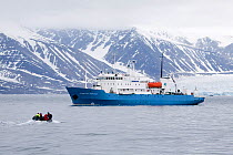 Zodiac returning to the Professor Mulchanov on a grey misty day. Kongsfjorden, Spitsbergen, Svalbard, Norway, June 2008.