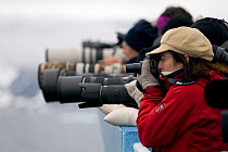 Photographers with long telephoto lenses outnumber the few using compact cameras on a photo safari in Svalbard, Norway, June 2008.