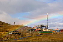Rainbow over Taubanesentralen, the funicular centre for coal, Skjaeringa, Longyearbyen. Spitsbergen, Svalbard, Norway, June 2006.