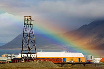 Rainbow over the dock buildings and mining hardware. Longyearbyen. Spitsbergen, Svalbard, Norway, June 2006.