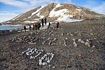 Expedition names and dates written in rocks on the beach at Beverleysundet. Nordastlandet, Svalbard, Norway, June 2006.