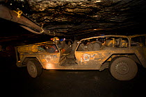 Tour leader driving along the tunnel on the working coal mine tour of Mine 7. Spitsbergen, Norway, June 2006.