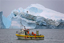 Fishing boat crossing the Ilulissat Icefjord, A UNESCO World Heritage site. West Greenland, 2008.