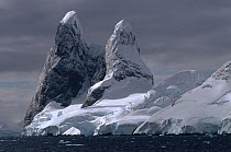 Snow capped Cape Renard at the north end of the Lemaire Channel, Antarctica.