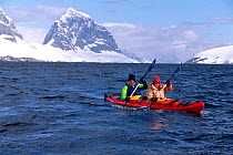 Eco tourists in a double kayak near Port Lockeroy, Antarctica. Editorial use only.