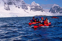 Eco tourists in double kayaks paddling near Port Lockroy, Antarctic Peninsula. Editorial use only.
