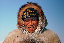 Inuit hunter with snow frozen on his face and clothing. Igloolik, Nunavut, Canada, 1987. Editorial use only.