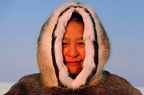 Inuit boy dressed in traditional reindeer skin parka. Igloolik, Nunavut, Canada, 1987.
