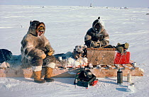 Two Inuit men making tea during a break on a hunting trip. Igloolik, Nunavut, Canada, 1987.
