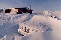 Truck covered in snow by winter snow storms in Igloolik, Nunavut, Canada, 1990.