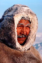 Inuk man from Igloolik with frozen snow on his face and clothing. Nunavut, Canada, 1990. Editorial use only.