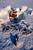 Inuit hunter jigging for polar cod though a hole in the ice. Igloolik, Nunavut, Canada, 1990.
