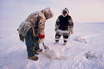 Inuit hunters with Arctic fox (Vulpes lagopus), caught in a trap near Baker Lake. Nunavut, Canada, 1982.