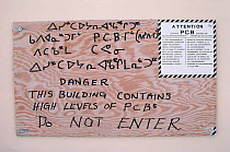 Warning sign for high levels of PCBs at an old DEW line station. Melville Peninsula, Nunavut, Canada, 1992.
