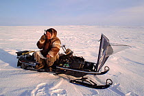 Inuit hunter using Iridium satellite telephone on the Melville Peninsula, Nunavut, Canada, 1999.