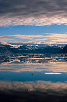 Mountains and altocumulus clouds reflected in Hall Basin. Ellesmere Island, Nunavut, Canada.