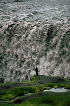 Tiny figure by Dettifoss, the most powerful waterfall in Europe. Iceland, 1992.