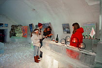 Tourists drinking in ice bar at the Ice Hotel, Jukkasjarvi, Sweden, 1993.