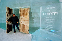 Visitor at the Reindeer (Rangifer tarandus) skin covered door to the Ice Hotel. Jukkasjarvi. Sweden, 2003.