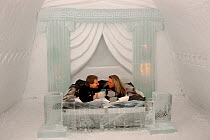 Couple toasting each other in the Roman Suite of Ice Hotel. Jukkasjarvi, Sweden, 2003.