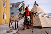 Sami herder on demonstration about injustice, with his Reindeer (Rangifer tarandus), Tromso, Norway, 2000.