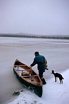 Innu hunter preparing canoe for hunting trip. Labrador, Canada, 1997.