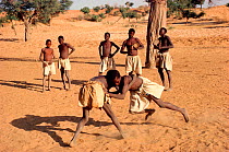 Dogon boys wrestling to beat of goatskin drums, a local tradition. Mali, West Africa, 1981.