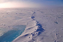 Turquoise meltpool beside pressure ridge in the polar pack ice, Arctic Ocean, 1998.