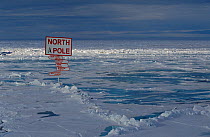 Sign at the North Pole, planted on summer sea ice by pressure ridge. North Pole, Arctic Ocean, 1998.
