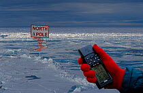 Sign at the North Pole and GPS (Global Positioning System). North Pole, Arctic Ocean, 1998. Digitally composed.