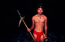 Reef fisherman with fish speared at night. Yap Island, Caroline Islands, Micronesia, 1984.