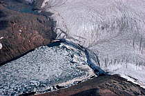 Glacier carving huge icebergs into sheltered fjord. Northwest Greenland, 1980.