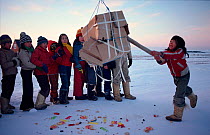 Inuit children playing game at party to welcome return of the sun. Northwest Greenland, 1980.