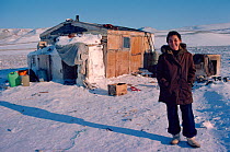 Inuit woman outside family hunting hut. Northwest Greenland, 1980.