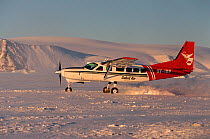 Cessna Caravan supply plane taking off from sea ice of Meteorite Bay. Savissivik, Northwest Greenland, 1996.