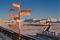 Sign at Greenland main international airport, Kangerlussuaq, Sondre Stromfjord, Greenland, with time taken to fly to various cities, 1996.