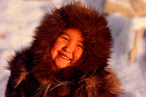 Inuit girl warmly dressed in fox fur hooded jacket (kapataq). Northwest Greenland, 1987.
