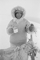 Inuk with mug of tea during break on hunting trip. Siorapaluk, Northwest Greenland, 1977.