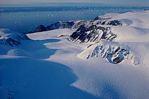 View down glacier from icecap to iceberg scattered sea. Cape York, Northwest Greenland, 1991.